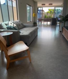 a living room with a couch and a table and chairs at Casa Alegria in São-José-do-Ribamar