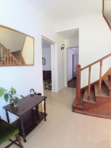 a living room with stairs and a table at Casa Francia in San Isidro