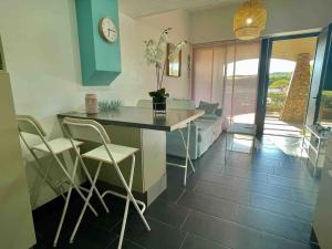 a kitchen with a table and chairs in a room at Appartement Seignosse bord de plage in Seignosse +4 photos
