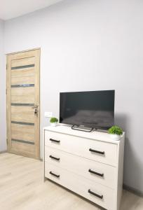 a white dresser with a television on top of it at Hayq Hotel in Yerevan