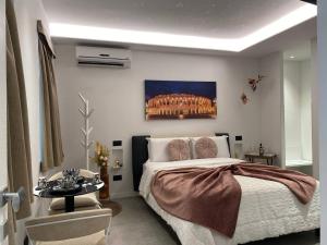 a bedroom with a large bed and a table at HOME Carpediem 2 in Verona