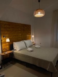 a bedroom with a bed with two towels on it at Villa Sunrise in Agia Paraskevi