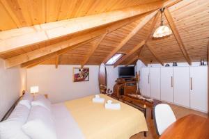 a room with a bed and a couch and a tv at Monica's Country House in Nafplio