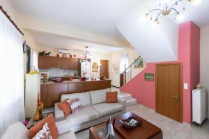 a living room with a couch and a kitchen at Monica's Country House in Nafplio