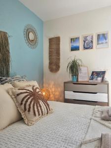 a bedroom with a bed with a pillow on it at Gîte "Tahiti", parking securise in La Roche-sur-Yon