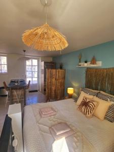 a bedroom with a large bed and a dining room at Gîte "Tahiti", piscine chauffée in La Roche-sur-Yon