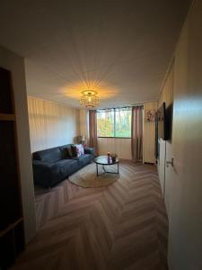 a living room with a couch and a table at B&B Twente in Enschede