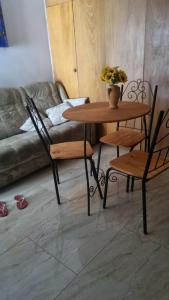 a table and chairs in a living room with a couch at Casa Margarida in Brasília