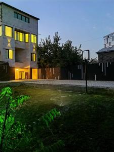 a building with its lights on in a yard at Hayq Hotel in Yerevan