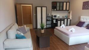 a living room with a couch and a table at Fotiadis - Cosy apartments and spectacular rooms in Veliko Tŭrnovo