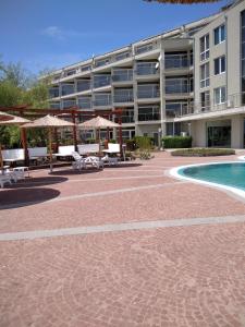 a resort with a swimming pool and a building at Studio Quatro - South Pearl - Sozopol in Sozopol