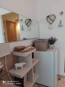 a mirror in a room with shelves and a mirror at Studio Quatro - South Pearl - Sozopol in Sozopol