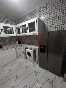 a kitchen with a refrigerator and a washing machine at SKA Zac Mbao in Rufisque +6 photos
