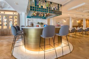 a bar in a restaurant with chairs and a bar counter at Vincci Centrum in Madrid +50 photos