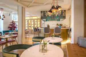 a restaurant with tables and chairs and a bar at Vincci Centrum in Madrid