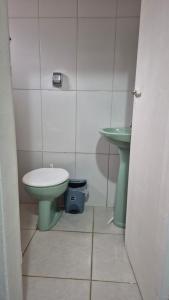 een badkamer met een groen toilet en een wastafel bij Quarto verde Asa Sul in Brasilia