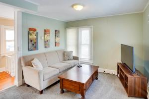 a living room with a couch and a tv at Saratoga Springs Apartment half Mi to Downtown in Saratoga Springs