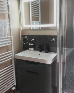 a bathroom with a sink and a shower at Brooklynn Guest House in Grantown on Spey +42 photos