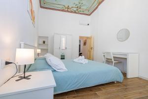 a bedroom with a bed and a desk and a table at San Biagio apartment in Finale Ligure