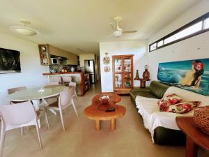 a living room with a couch and a table at Casa Turmalina in Japaratinga +46 photos