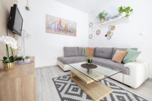 a living room with a couch and a coffee table at Apartments Antea in Makarska