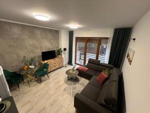 a living room with a couch and a table at Przy Złotych Piaskach 2 in Sława