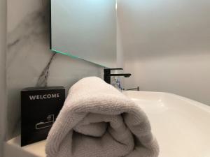 a white towel is sitting on a bathroom sink at Ideal longue durée centre ville in Pau +21 photos