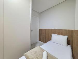 Ένα ή περισσότερα κρεβάτια σε δωμάτιο στο Apt Centro de Foz Novo - 2 quartos Alto Padrão