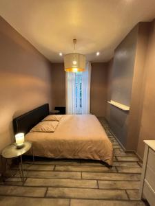 a bedroom with a large bed and a window at T2 cosy proche commodités in Marseille
