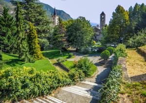 an aerial view of a garden with a building in the background at Hotel Susa in Susa