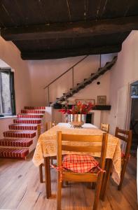 a dining room with a table with flowers on it at La Corte sul lago in Ameno