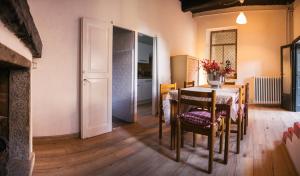 a dining room with a table and chairs and a door at La Corte sul lago in Ameno