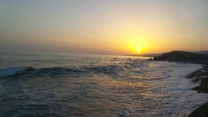 a sunset over the ocean with the sun setting at B&B La Greka in Condofuri