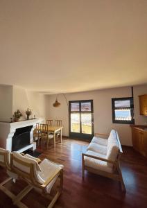 a living room with white furniture and a fireplace at Apartamento con chimenea - Golfes Cal Gravat in Montsonis