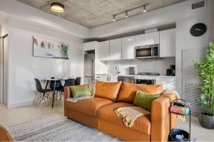 a living room with a couch and a kitchen at Miso 2 BD - Skyline View Patio Gym Pool & AC in Calgary