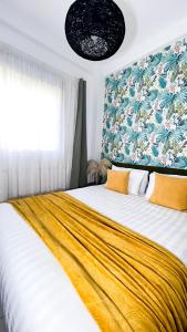 a bedroom with a large bed with a yellow blanket at Appartamento Fronte al Mare in Tangier +27 photos