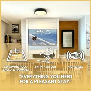 a living room with a tv on a wall at Appartement 6 8 personnes, balcon vue montagne, ski aux pieds in Val Thorens