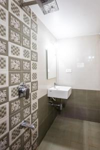 a bathroom with a sink and a mirror at Susegad Shores - Chic 1BHK Coastal Escape in Siolim +22 photos