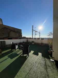 a patio with two chairs and a table on a roof at Studio et terrasse près de Paris in Suresnes