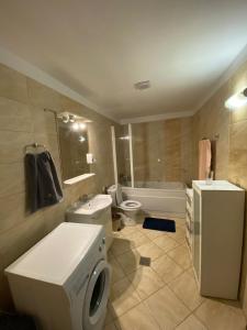 a bathroom with a white toilet and a sink and a tub at Dulcinea Life in Deva +14 photos