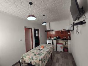 a small kitchen with a table in a room at Cabañas LOS NARANJOS in Andalgalá