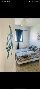 a bedroom with a bed with a picture of a turtle on the wall at la villa TIKALIKATA in Saint-Joseph +31 photos