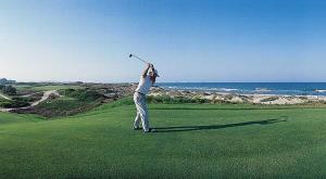 a man swinging a golf club on a golf course at Fantastic beach apartment near Valencia in Valencia