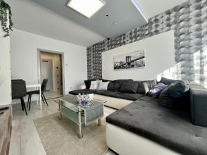 a living room with a couch and a table at GreatForestSportAndSpaUniversityFlat in Debrecen