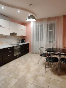 a kitchen with a table and chairs and a dining room at велика двокімнатна Данькевича in Kyiv