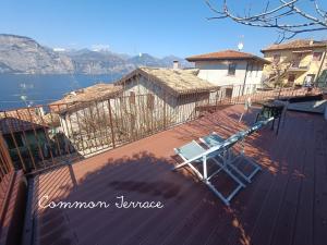 a deck with a chair on top of a house at Ca de l'Angelon - Apartment Sardella in Brenzone sul Garda
