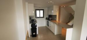 a small kitchen with white cabinets and a counter top at Chilches Sunset Beach in Vélez-Málaga