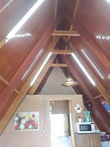 a room with a ceiling with wooden beams at Cabana das montanhas in Bueno Brandão