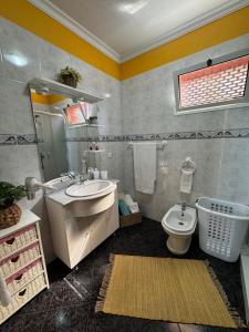 a bathroom with a sink and a toilet at Ponta do Sol Villa in Ponta do Sol +51 photos