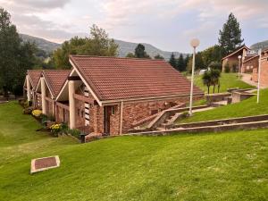 an image of a house with a green lawn at The Willow Suite - Larola 35 in Clarens